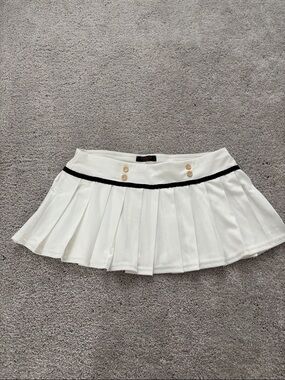 White Pleated Mini Skirt with Black Trim and Gold Buttons